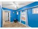 Small blue bedroom with wood floors, a window with sheer curtains, and a closet at 2705 Grantham Ct, Orlando, FL 32835