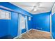 Blue bedroom with wood floors, a window with sheer curtains, and a closet at 2705 Grantham Ct, Orlando, FL 32835