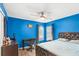 Blue bedroom with wood floors, a double bed, and a home office at 2705 Grantham Ct, Orlando, FL 32835