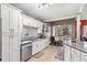Updated kitchen boasting white cabinets, granite countertops, and stainless steel appliances at 2705 Grantham Ct, Orlando, FL 32835