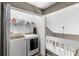 Upper-level laundry room with washer, dryer, and shelving at 2705 Grantham Ct, Orlando, FL 32835