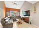 Spacious living room with a large sectional sofa and a large TV at 2705 Grantham Ct, Orlando, FL 32835