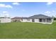 Large backyard with grassy lawn and home featuring screened porch at 2841 Derby Dr, Deltona, FL 32738