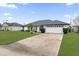 House exterior showcasing a white garage door and landscaping at 2841 Derby Dr, Deltona, FL 32738