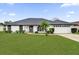Single-story home with a two-car garage and well-manicured lawn at 2841 Derby Dr, Deltona, FL 32738