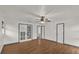 Main bedroom with wood flooring, ceiling fan and multiple doors at 2841 Derby Dr, Deltona, FL 32738