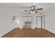 Main bedroom with wood flooring, ceiling fan, and doors to en-suite bath at 2841 Derby Dr, Deltona, FL 32738