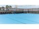 Outdoor basketball court with blue surface and surrounding fence at 297 Jetty Way, Davenport, FL 33897