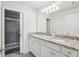 Clean bathroom with double sinks and a walk-in shower at 297 Jetty Way, Davenport, FL 33897