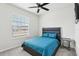 Spacious bedroom with a ceiling fan and large window at 297 Jetty Way, Davenport, FL 33897