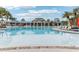 Resort-style community pool with lounge chairs and umbrellas at 297 Jetty Way, Davenport, FL 33897