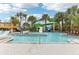 Resort-style pool with waterslides and plenty of lounge chairs at 297 Jetty Way, Davenport, FL 33897