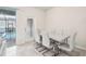 Dining area with white table and chairs, near pool access at 297 Jetty Way, Davenport, FL 33897