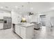 Modern kitchen with white cabinets, granite island, and stainless steel appliances at 297 Jetty Way, Davenport, FL 33897