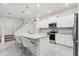 Modern kitchen with white cabinets, granite island, and stainless steel appliances at 297 Jetty Way, Davenport, FL 33897