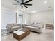Spacious living room with gray couches and a coffee table at 297 Jetty Way, Davenport, FL 33897
