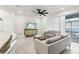 Living area with large TV, comfortable seating, and pool view at 297 Jetty Way, Davenport, FL 33897