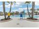 Tranquil resort pool with palm trees and seating at 297 Jetty Way, Davenport, FL 33897