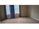 Bright bedroom with neutral carpeting and window coverings at 4145 Plantation Cove Dr, Orlando, FL 32810