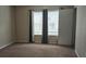 Well-lit bedroom with neutral carpet and window coverings at 4145 Plantation Cove Dr, Orlando, FL 32810
