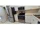Modern kitchen with stainless steel appliances and white cabinets at 4145 Plantation Cove Dr, Orlando, FL 32810