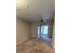 Living room with neutral walls, carpet floors, and sliding glass door to patio at 4145 Plantation Cove Dr, Orlando, FL 32810