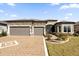 Two-story home with stone accents and three-car garage at 5599 Sw 92Nd Avenue Rd, Ocala, FL 34481