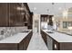 Modern kitchen with dark cabinetry, white quartz countertops, and high end appliances at 5599 Sw 92Nd Avenue Rd, Ocala, FL 34481