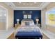 Main bedroom with blue shiplap accent wall, large window, and chandelier at 5599 Sw 92Nd Avenue Rd, Ocala, FL 34481