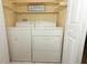 Laundry closet with washer, dryer, and shelving at 580 Cranes Way # 156, Altamonte Springs, FL 32701