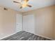 Bright bedroom with ceiling fan, large closet, and wood-look floors at 6118 Westgate Dr # 101, Orlando, FL 32835