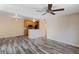 Living room with wood-look floors and kitchen bar at 6118 Westgate Dr # 101, Orlando, FL 32835