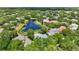 Wide aerial shot of luxury homes nestled among trees and ponds under a clear blue sky at 6241 Blakeford Dr, Windermere, FL 34786