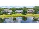 An aerial showcases the lake view, backyard, pool, and beautiful landscaping of this exquisite property at 6241 Blakeford Dr, Windermere, FL 34786