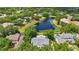 Aerial shot of the home and surrounding area with lush landscaping and a nearby lake at 6241 Blakeford Dr, Windermere, FL 34786