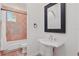 Bathroom features tile accents in the shower/tub area and a pedestal sink with a black framed mirror at 6241 Blakeford Dr, Windermere, FL 34786
