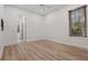 This bedroom features light wood floors, a ceiling fan, and natural light from a window with wood blinds at 6241 Blakeford Dr, Windermere, FL 34786