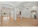 Bright, open-concept living area with modern wood floors and arched doorways at 6241 Blakeford Dr, Windermere, FL 34786