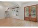 Bright and airy living room with wood floors, decorative mirror and detailed doorway at 6241 Blakeford Dr, Windermere, FL 34786