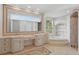 Elegant bathroom featuring dual sinks, mosaic tile, and soaking tub at 6241 Blakeford Dr, Windermere, FL 34786