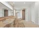 Elegant bathroom featuring dual sinks, mosaic tile, and soaking tub at 6241 Blakeford Dr, Windermere, FL 34786