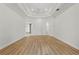 Bright main bedroom with wood floor, tray ceiling, and doors to bathroom at 6241 Blakeford Dr, Windermere, FL 34786