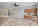 This covered outdoor kitchen includes wooden cabinets, tile countertops, and views of the backyard at 6241 Blakeford Dr, Windermere, FL 34786