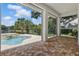 The covered outdoor seating area boasts backyard and pool views with interlocking brick flooring at 6241 Blakeford Dr, Windermere, FL 34786