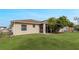 House backyard with green lawn and screened porch at 63 York Ct, Kissimmee, FL 34758
