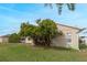 House backyard with green lawn and trees at 63 York Ct, Kissimmee, FL 34758
