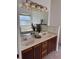 Bathroom vanity featuring dual sinks, a large mirror, and tile flooring at 63 York Ct, Kissimmee, FL 34758