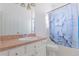 Small bathroom with shower/tub combo and floral curtain at 63 York Ct, Kissimmee, FL 34758