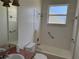 Bathroom featuring a tiled tub/shower combo and light fixtures at 63 York Ct, Kissimmee, FL 34758