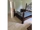 Bedroom featuring tile flooring, dark furniture, and a decorative wrought iron bed frame at 63 York Ct, Kissimmee, FL 34758